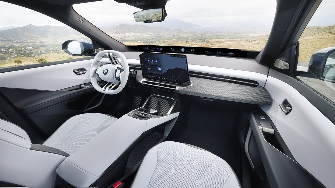 BMW iX3 50 xDrive (2025-…) interior photo, front seat, driver seat, dashboard, steering wheel, infotainment, cockpit