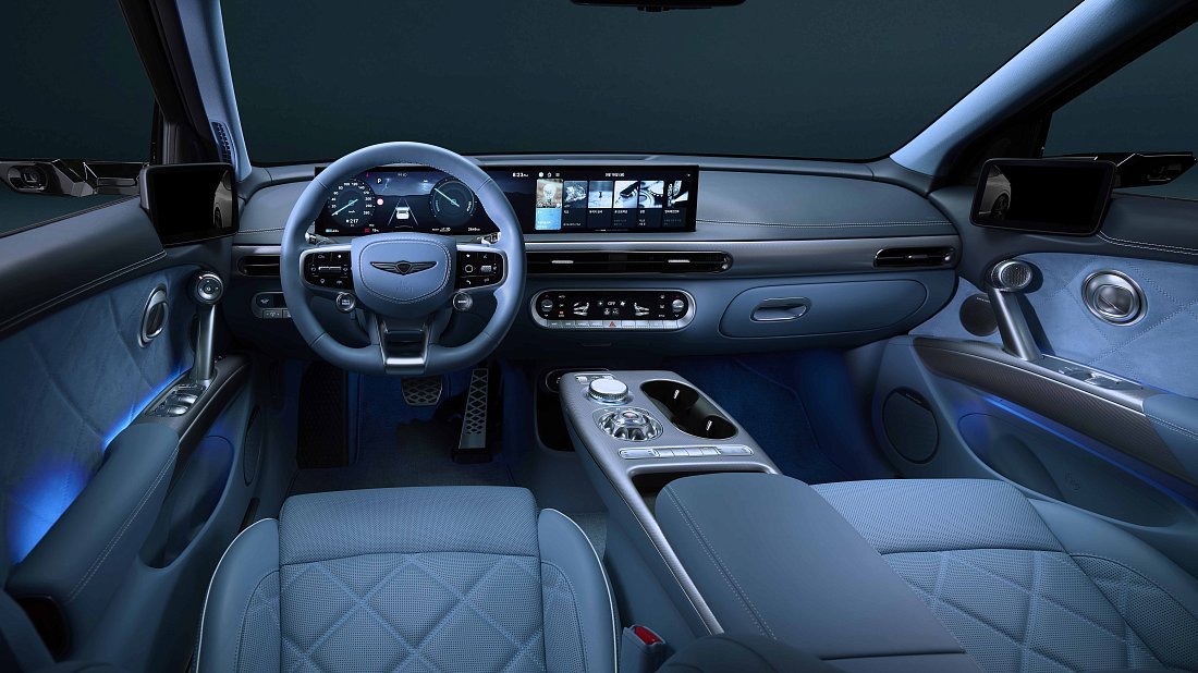Genesis GV60 Standard RWD (2025-…) interior photo, front seat, driver seat, dashboard, steering wheel, infotainment, cockpit