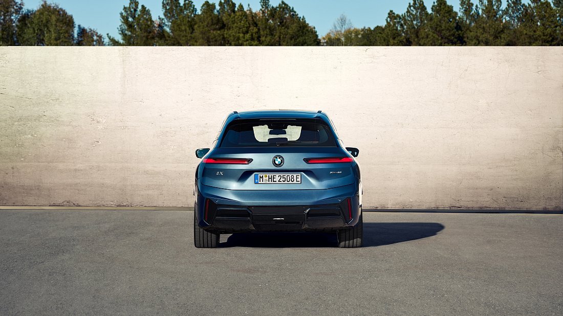BMW iX xDrive60 (2025-...) rear view, taillights, trunk, spoiler, badge, bumper, exterior