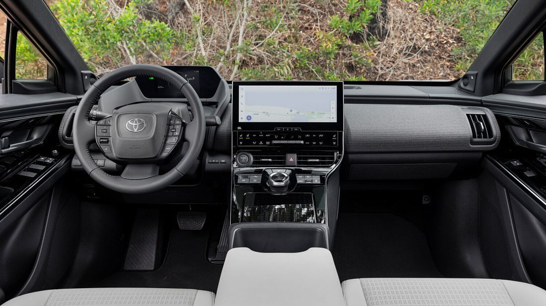 Toyota bZ4X FWD (2022-2025) interior photo, front seat, driver seat, dashboard, steering wheel, infotainment, cockpit
