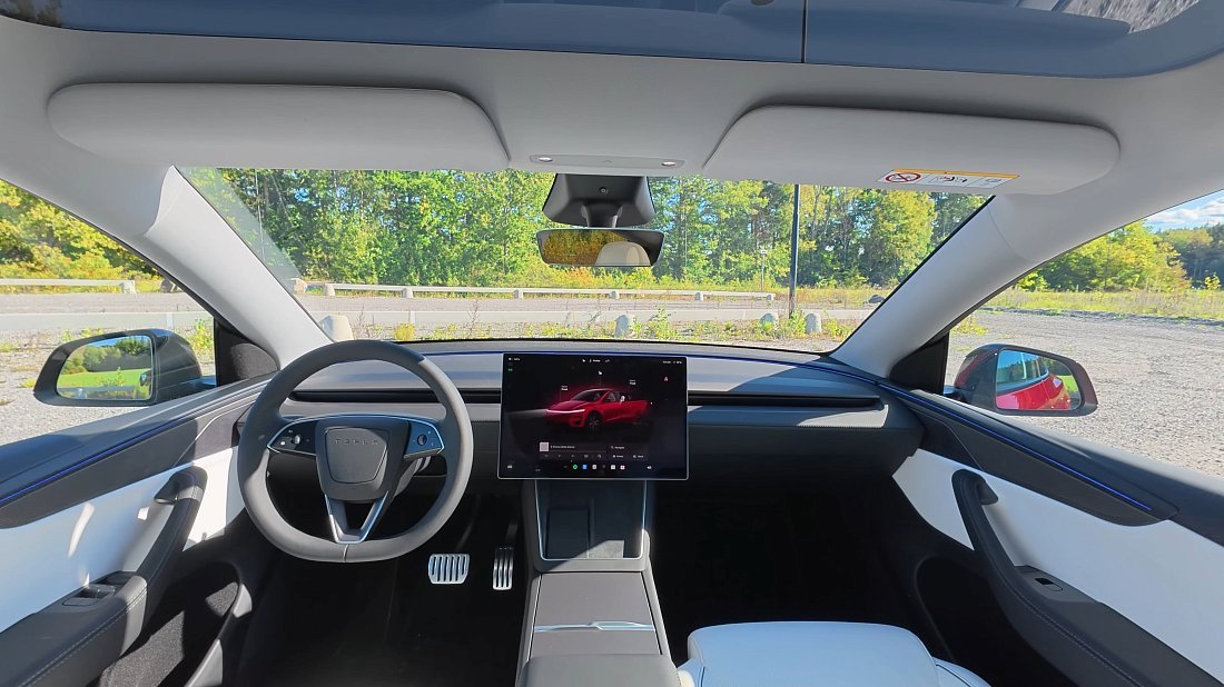 Tesla Model Y Performance (2025-...) interior photo, front seat, driver seat, dashboard, steering wheel, infotainment, cockpit